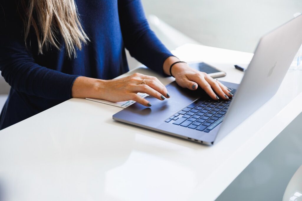 Accountant processing payroll on a laptop